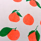 A close up detail of the print showing six other satsumas and their expressions. In the bottom row the most leftright smiles at a double leafed citrus who returns their look with a closed eye frown. 