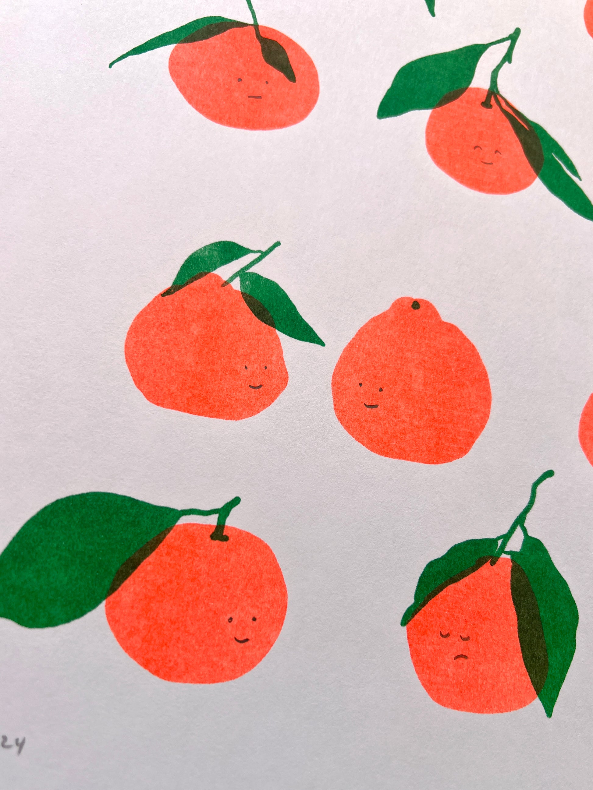 A close up detail of the print showing six other satsumas and their expressions. In the bottom row the most leftright smiles at a double leafed citrus who returns their look with a closed eye frown. 