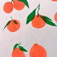 A close up of the print showing sis sets of satsumas with varying faces. In the top right corner two huddled satsumas attached by a forked stem give a closed eye smile towards one another. 