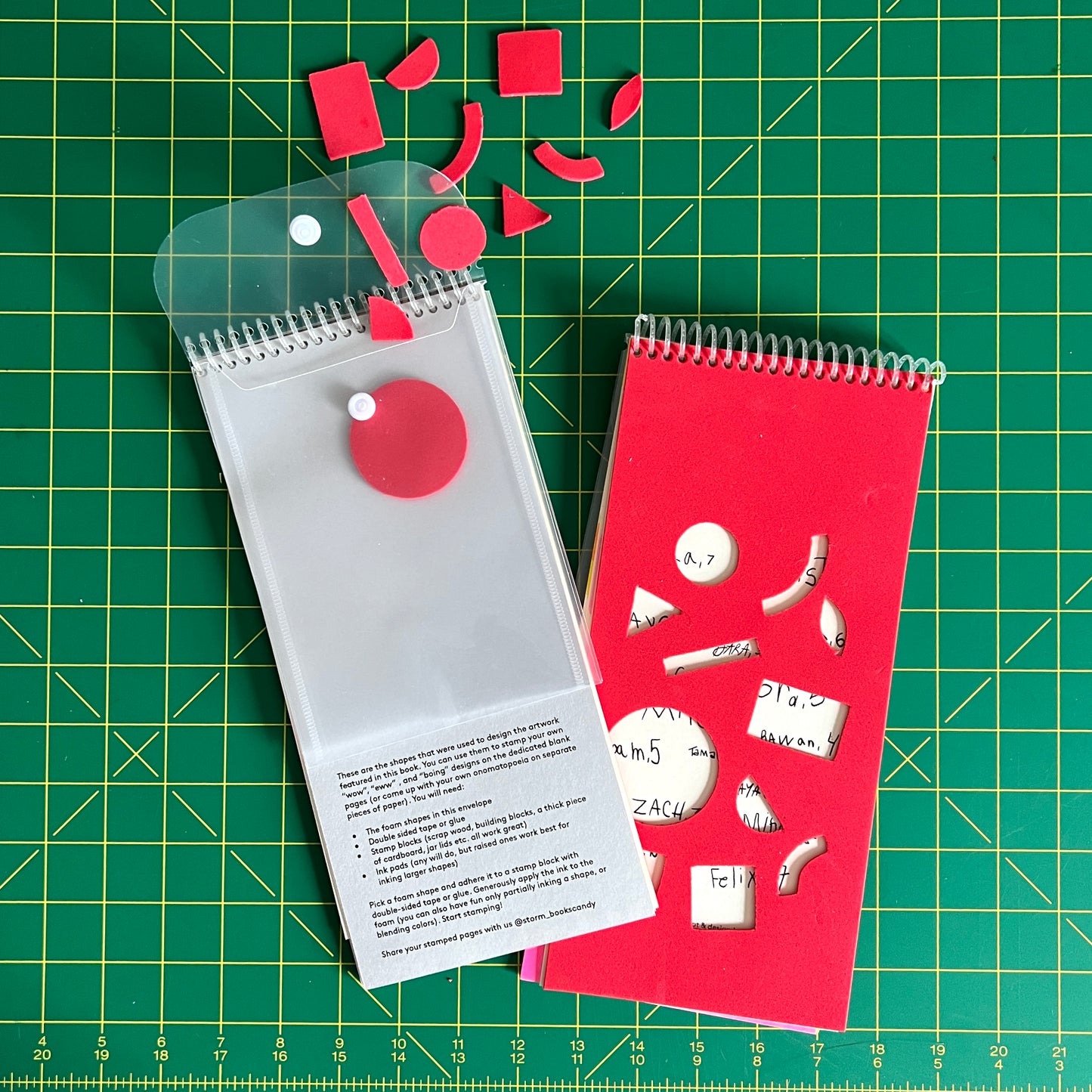 Two copies of the book are stacked to front and back of the book. On the backside a clear plastic resealable envelope has been coil bound into the book. Spilling out of it are foam shapes, taken from the dicut holes on the over. On Gray cardstock, instructions are printed on how to use them to make your own stamps. 